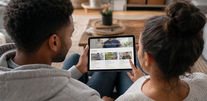 Couple on a tablet reading a local business website with visible customer ratings