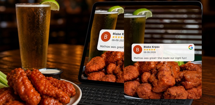 Tablet on a bar table showing a Share Reviews graphic with a Google review on buffalo wings